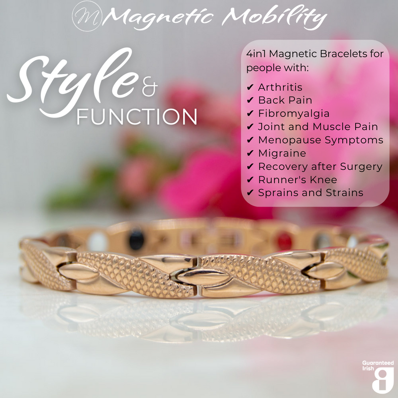 Front view of the Snapdragon Dawn 4in1 Magnetic Bracelet, rose gold coloured bracelet with snakeskin type designs, designed for pain relief, featuring various therapeutic elements. The bracelet is shown on a reflective surface with a pink flower behind it. 