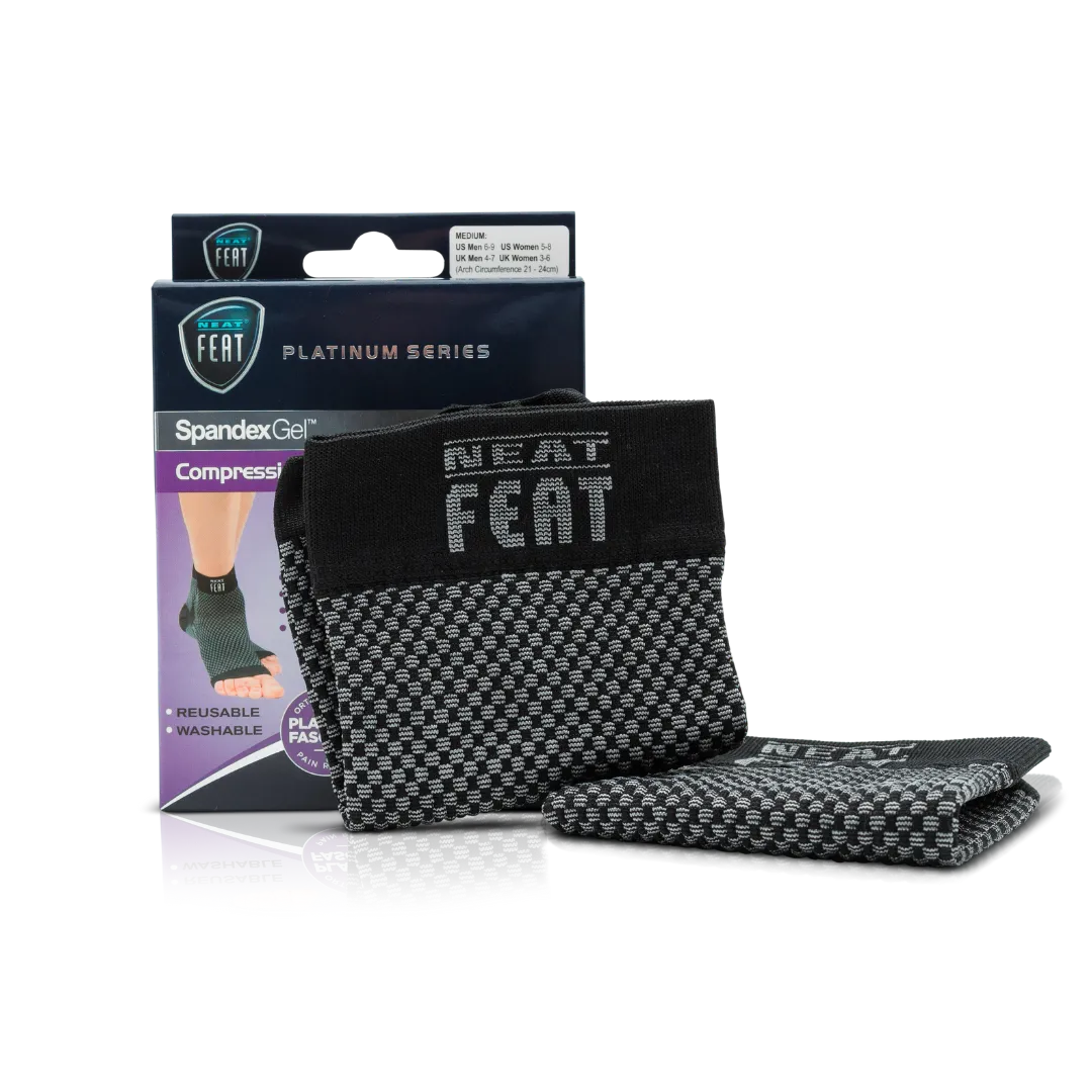 Platinum Series Spandex Gel Compression Arch Sock. The image shows the product box alongside the sock resting against it. The sock is black and grey, while the box is mostly dark blue and purple. The front of the box features an image of a foot demonstrating the fit of the sock, highlighting its arch support benefits.