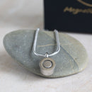 Back view of the Magnetic Mobility Magnetic Necklace showing the strong Neo-dynimum magnet. Presented on a flat stone 