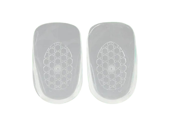 Two white, semi-translucent Neat Feat Gel Heel Cushions side by side, showcasing their soft, contoured design for heel support and comfort.