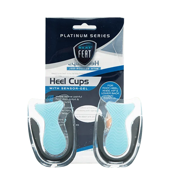 Both Neat Feat Heel Cups standing upright in front of the packaging. The cups are mostly clear, featuring a blue heel pad and a black trim around the base of the heel for added support.